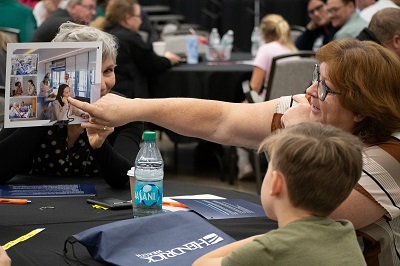 Photo of woman pointing to picture in teaching student about healthcare.