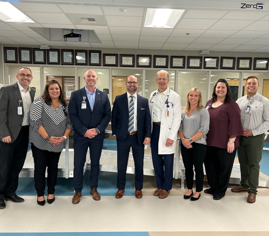 Group photo of 8 people in Hendrick Rehabilitation Hospital inpatient gym