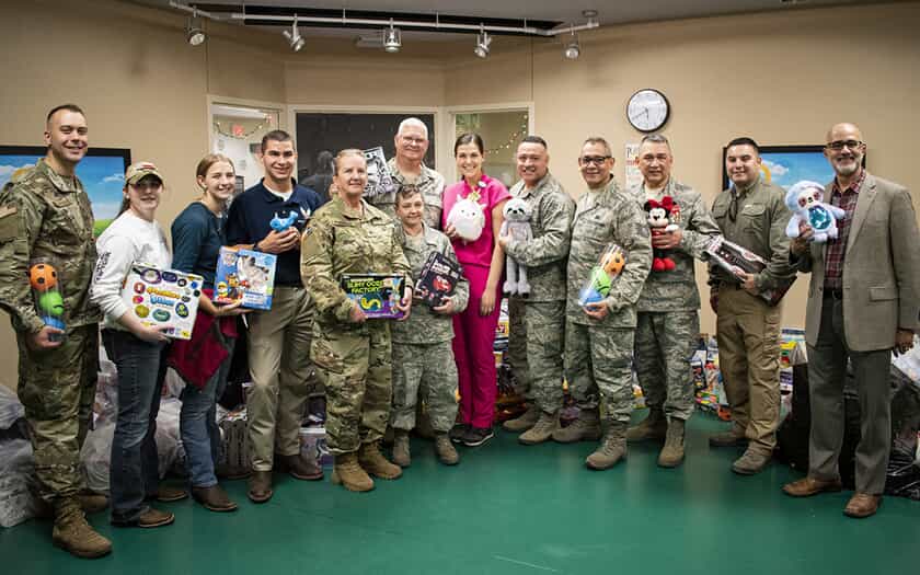 military personnel holding toys