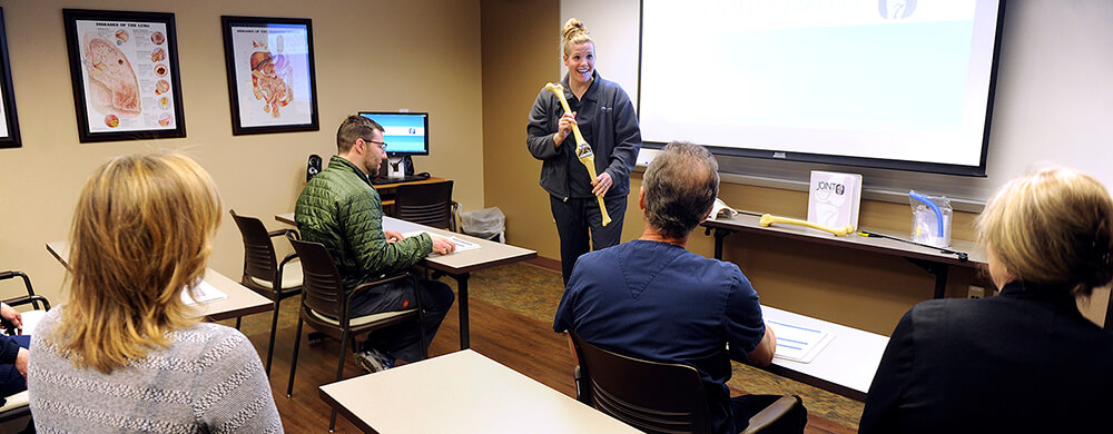 woman holding bone teaching a class