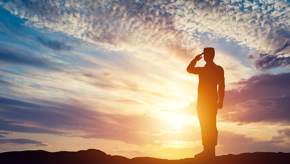 Soldier saluting sunset