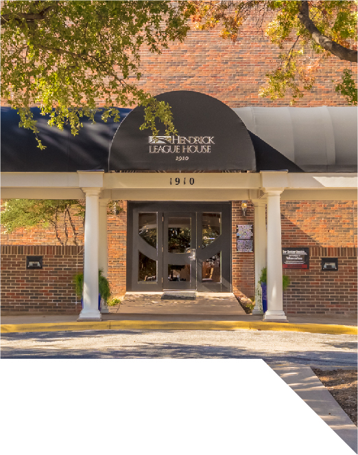 Hendrick League House - brick building with black awning and white columns